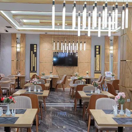 Ein elegantes Restaurant mit modernen Holzmöbeln, stilvollen Blumenarrangements und einer warmen, einladenden Atmosphäre.