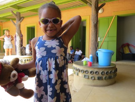 Ein einheimisches Mädchen mit Sonnenbrille und Teddy - Namibia mit Jugendlichen