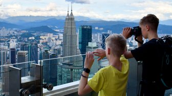 Kinder genießen die Aussicht vom KL Tower auf die Petronas Towers in Kuala Lumpur – Malaysia & Borneo Reise mit Kindern