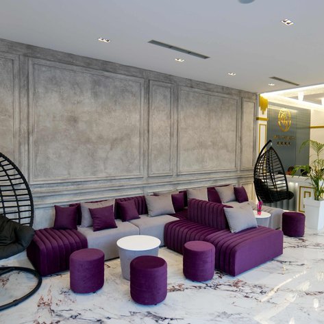 Der elegante Loungebereich des Himare Chimaera Hotels zeigt stilvolle Möbel in lila und grau auf einem marmorierten Boden.
