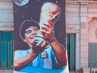 Ein großes Banner zeigt einen jubelnden Diego Maradona, der den Weltmeisterschaftspokal in die Höhe hält.