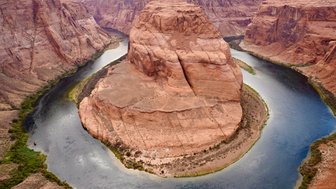 Ein beeindruckender Blick auf Horseshoe Bend, wo der Colorado River in einer markanten Kurve durch die roten Felsen fließt.