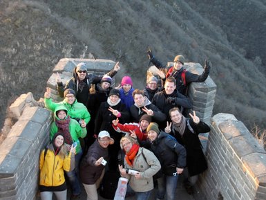 Glückliche Reisegruppe nimmt Erinnerungsfotos auf der beeindruckenden Großen Mauer bei Peking auf – China mit Kindern