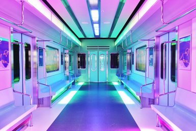 Ein futuristischer U-Bahn-Wagen mit bunten Neonlichtern und leeren Sitzbänken, der eine moderne Atmosphäre ausstrahlt.