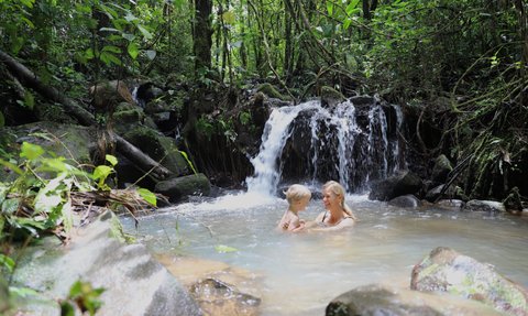 Mutter und Kind genießen das Baden im natürlichen Wasserbecken in La Tigra – Costa Rica Familienreise