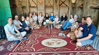 Gruppe sitzt auf dem Boden im Oman – Oman Reise mit Kindern