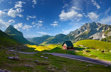 Eine einsame Hütte steht unmittelbar an einem Bergpass inmitten der Natur