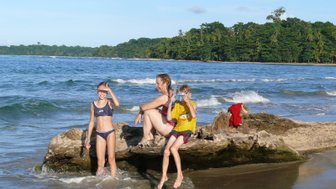 Eltern und Kinder plantschen gemeinsam im Meer – Costa Rica Reise mit Kindern