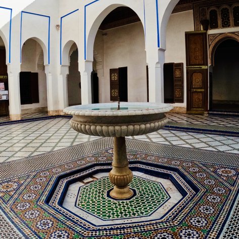Brunnen mit detailreichen Zellij-Fliesen im Innenhof eines Riads in Marrakesch – Marokko Familienreise
