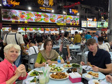 Familie genießt ein gemeinsames Abendessen in einem Restaurant in Kuala Lumpur – Malaysia & Borneo mit Kindern