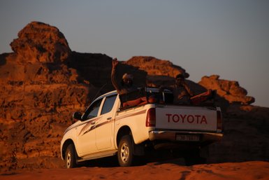 Jeep mit Beduine bei Sonnenuntergang - Jordanien mit Kindern