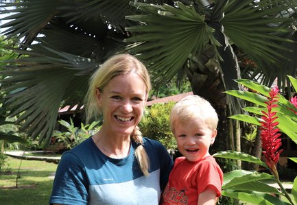 Mutter hält Kleinkind vor tropischen Palmen – Costa Rica Reise mit Kindern