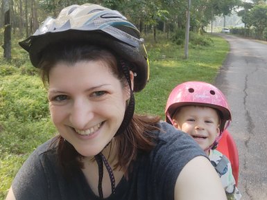 Mutter fährt mit ihrem Kind bei einer Fahrradtour durch Malakka – Malaysia & Borneo Familienreise