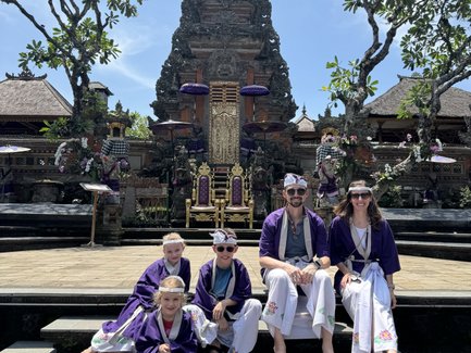 Familie in balinesischer Kleidung besucht den Pura Taman Saraswati Tempel – Bali mit Kindern