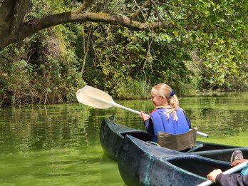 Mädchen genießt eine Kanutour auf dem ruhigen Duluti-See – Tansania mit Kindern
