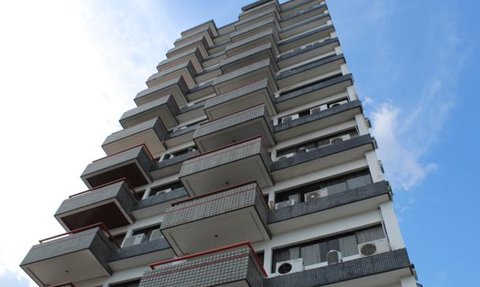 Ein hoch aufragendes Gebäude mit mehreren Balkonen, das zum Himmel hin aufragt und eine moderne Architektur ausstrahlt.