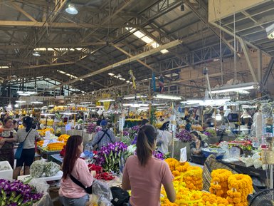 Stände mit farbenfrohen Blumen auf dem lebhaften Pad Klong Talad Blumenmarkt – Thailand Familienreise