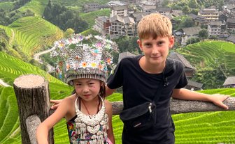 Begegnung zwischen einem einheimischen Mädchen und einem Jungen in den Longsheng-Reisterrassen – China mit Kindern