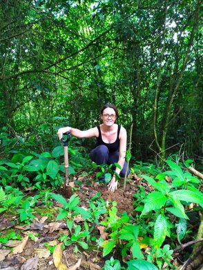 Frau lächelt beim Baumpflanzen in La Tigra – Costa Rica Reise mit Kindern