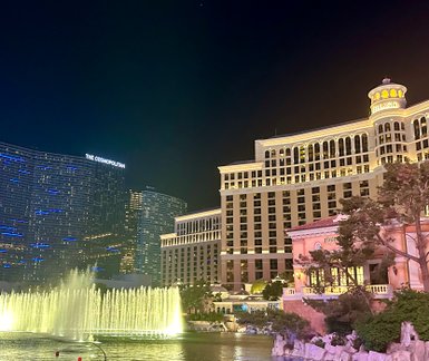 Die beeindruckenden Wasserspiele des Bellagio erleuchten die Nacht, während die modernen Gebäude im Hintergrund strahlen.