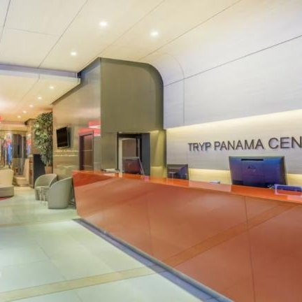 Der Empfangsbereich des TRYP Panama Centro Hotels zeigt eine moderne, einladende Atmosphäre mit eleganten Möbeln.