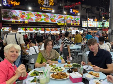 Familie genießt ein gemeinsames Abendessen in einem Restaurant in Kuala Lumpur – Malaysia & Borneo mit Kindern