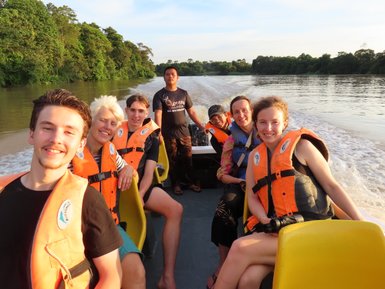 Familie posiert gemeinsam für ein Foto auf dem Boot während der Flusssafari am Kinabatangan – Malaysia & Borneo Familienreise