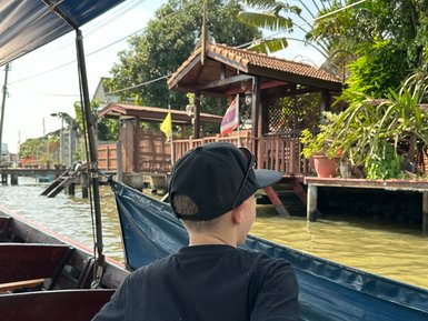 Kind genießt eine Bootstour durch die Wasserwege – Thailand mit Kindern