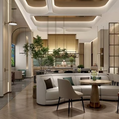 Ein eleganter Innenraum mit modernen Möbeln, Pflanzen und warmem Licht schafft eine einladende Atmosphäre im Hotel.