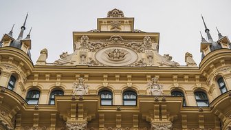Die prächtige Fassade eines Jugendstilgebäudes in Riga, verziert mit kunstvollen Skulpturen und eleganten Fenstern.