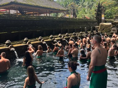 Gläubige und Besucher im Wasserbecken des Tirta Empul Tempels – Bali Reise mit Kindern