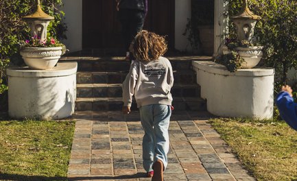 Junge läuft über das Gelände der Skeiding Guest Farm – Südafrika mit Kindern