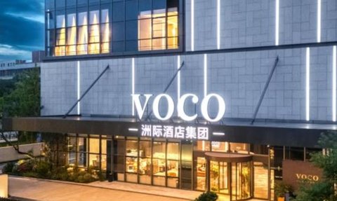 Das moderne Voco-Hotel in Chengdu strahlt Eleganz aus, mit einer stilvollen Fassade und einladenden Lichtern am Abend.