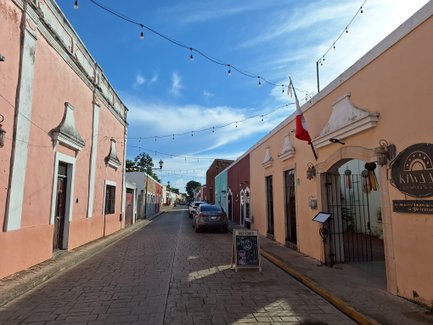 Eine malerische Straße in Valladolid mit bunten Gebäuden und einer entspannten Atmosphäre unter einem blauen Himmel.