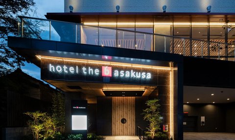 Das moderne Hotel the b Asakusa erstrahlt in warmem Licht und lädt mit seiner einladenden Fassade zum Verweilen ein.