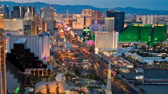 Die beeindruckende Skyline von Las Vegas erstrahlt in bunten Lichtern, während die Nacht hereinbricht und die Stadt lebendig wird.