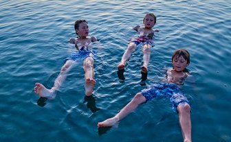 Familie im Toten Meer bei Sonnenuntergang