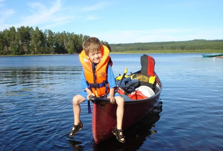 Familienreise_Schweden_Kind sitzt auf Kanu
